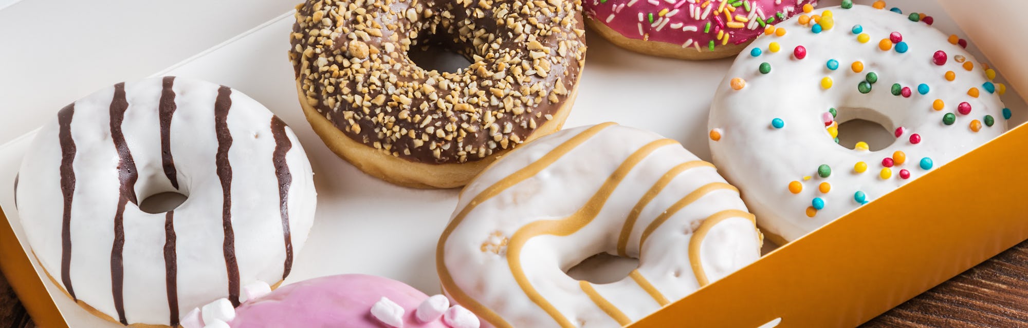 glazed donuts with different fillings in the box