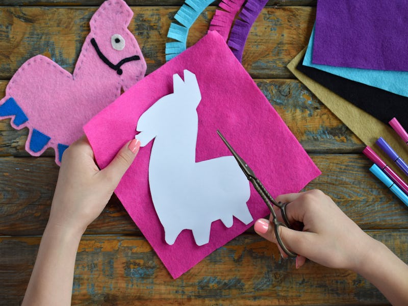 Making pink lama. Sewing toys from felt with your own hands. DIY concept for children. Handmade craf...