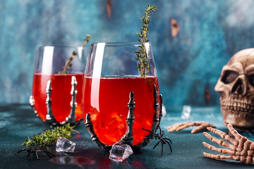 Bloody Halloween party cocktail garnished with thyme, Cranberry punch