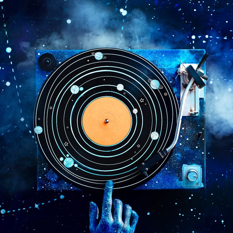 Creative music flat lay, vinyl record with solar system drawing and a galaxy hand. Astronomy concept