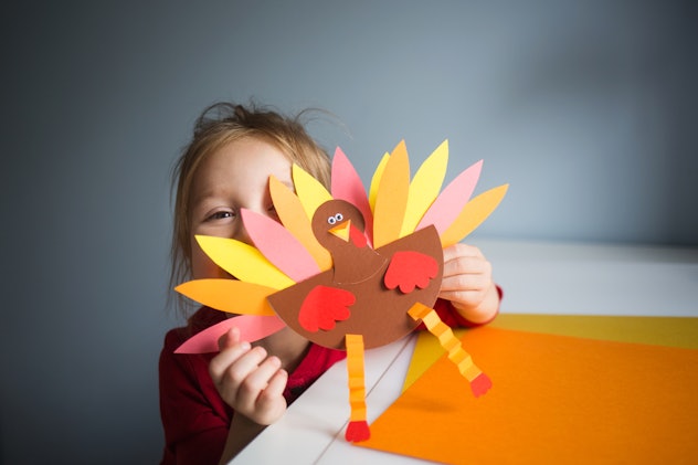 paper craft for kids. DIY Turkey made for thanksgiving day. create art for children. girl playing wi...