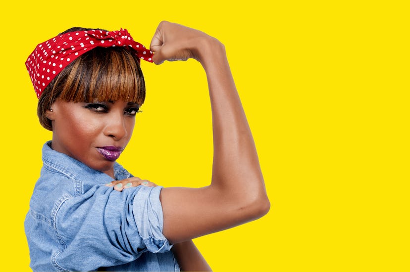 Beautiful woman dressed as the iconic Rosie the Riveter