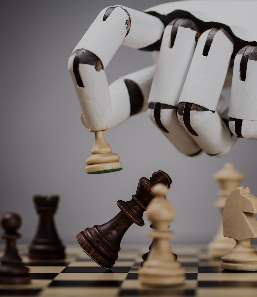 Close-up Of A Robot's Hand Playing Chess