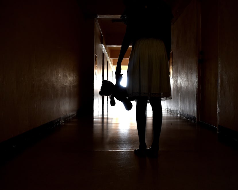 The Ghost of a little girl. Silhouette girls with a toy. A lost childhood. Bringing a child in the h...