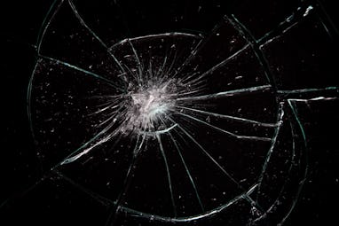 Broken glass with lots of cracks, studio shot with black background