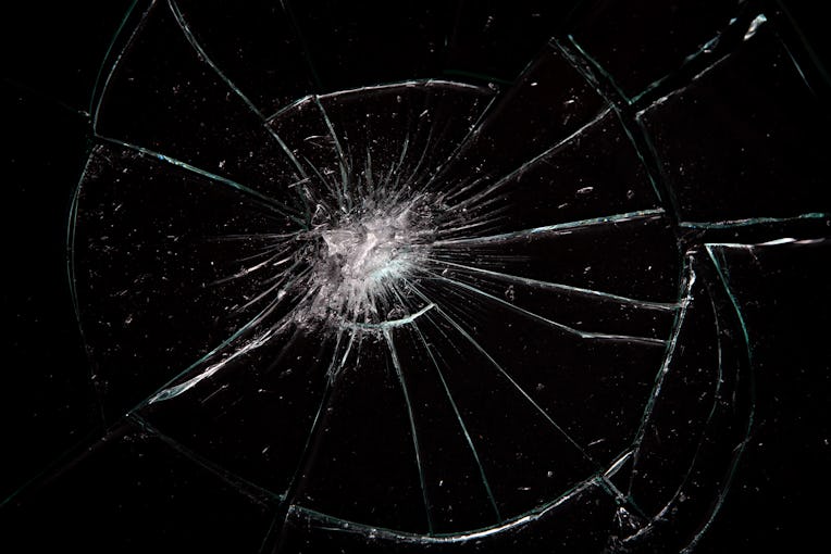 Broken glass with lots of cracks, studio shot with black background