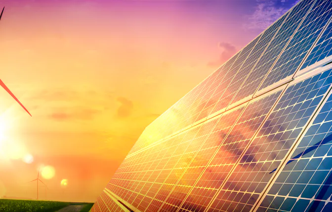 Wind Turbines And Solar Panels At Sunset - Renewable Energy Concept