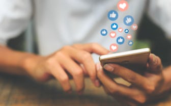 Young man using smart phone,Social Distancing ,Working From Home concept.