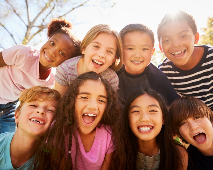 Multi-ethnic group of schoolchildren on school trip, smiling