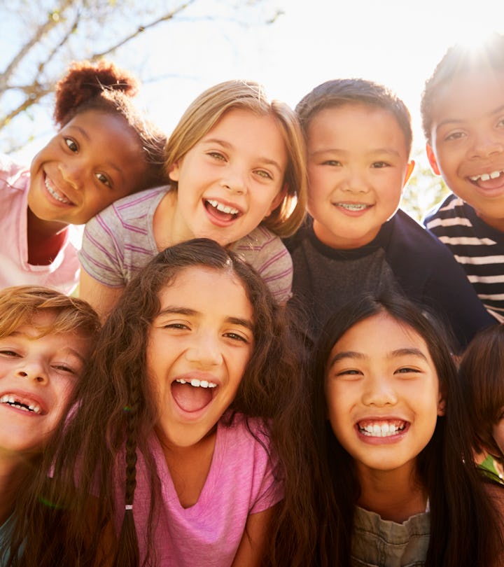 Multi-ethnic group of schoolchildren on school trip, smiling