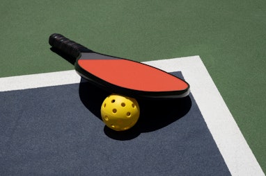Pickleball Time Out with Ball and Paddle on Court