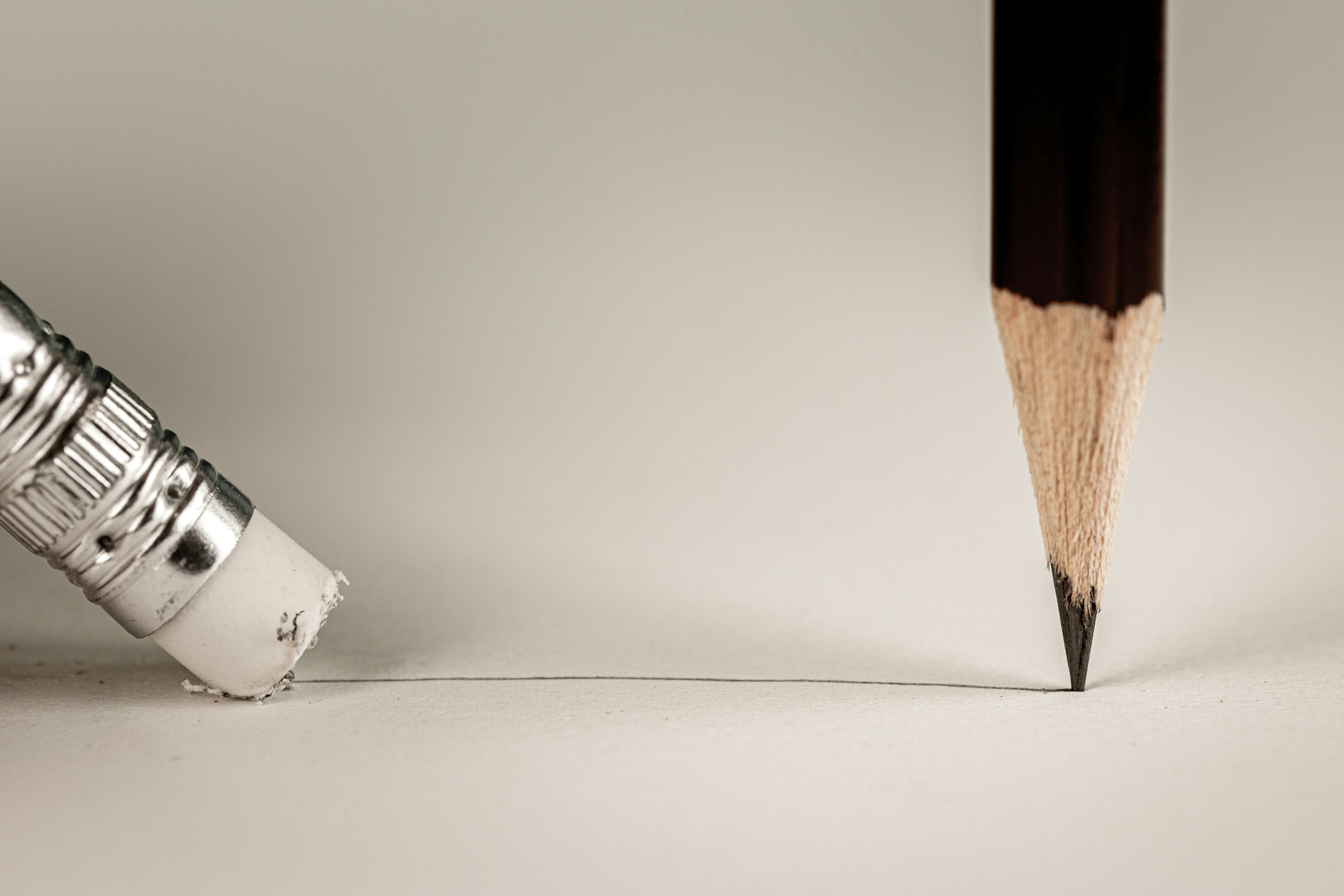 Closeup pencil eraser or delete on paper for removing a written mistake.Examination for fix and corr...