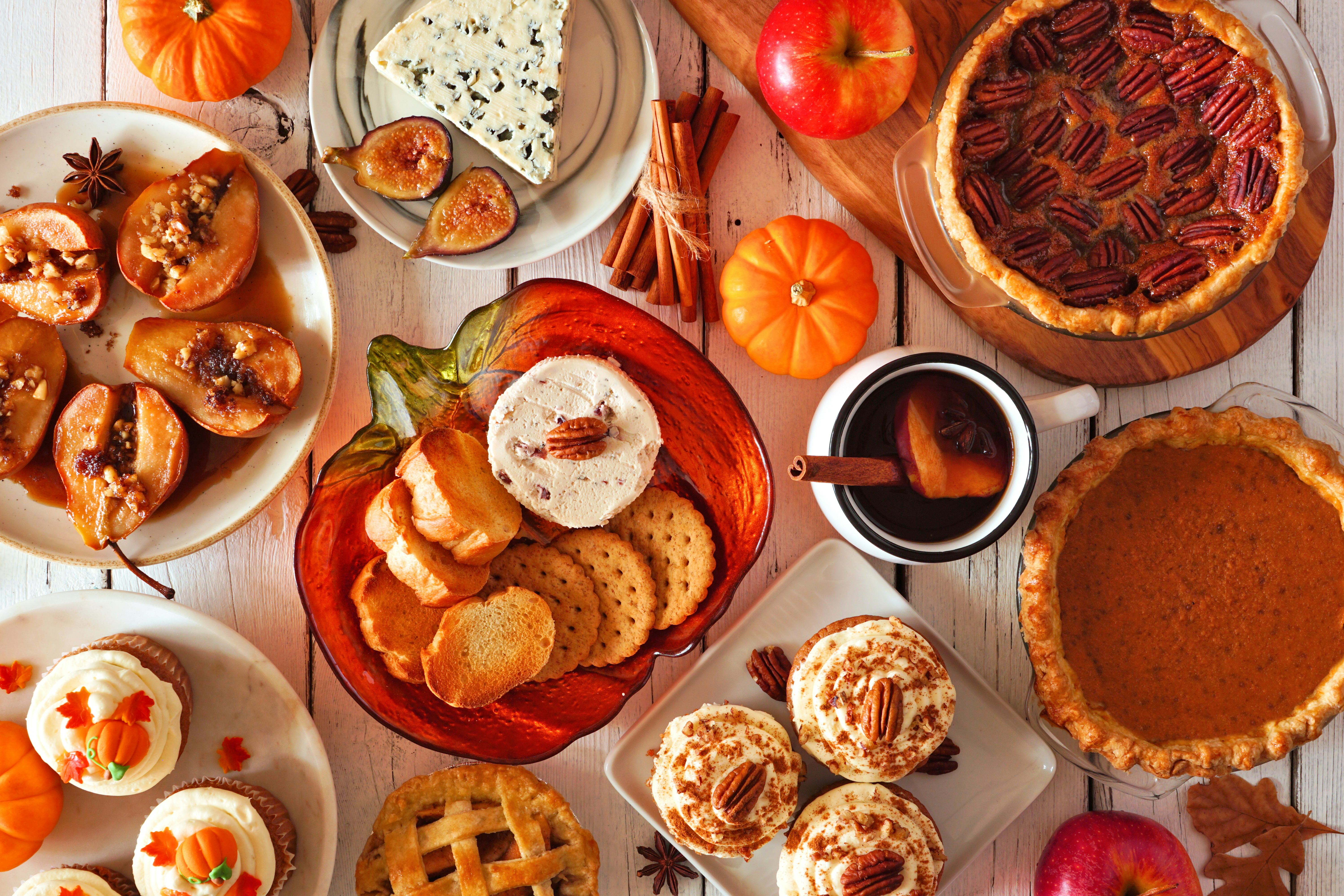 Autumn food concept. Selection of pies, appetizers and desserts. Top view table scene over a white w...