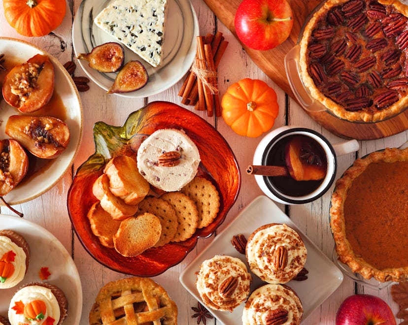 Autumn food concept. Selection of pies, appetizers and desserts. Top view table scene over a white w...