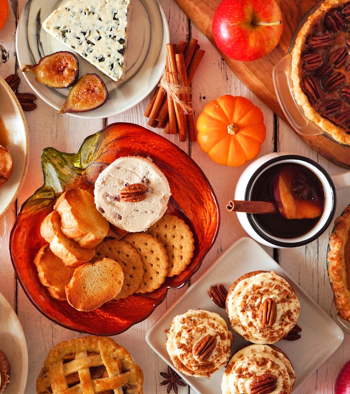 Autumn food concept. Selection of pies, appetizers and desserts. Top view table scene over a white w...