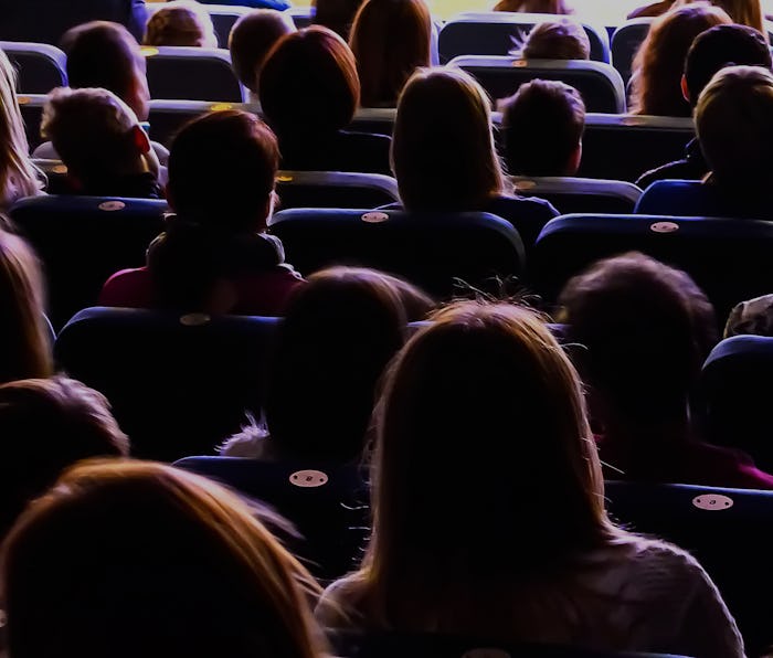People in the auditorium watching a theater performance