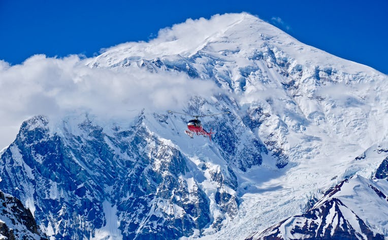 A rescue helicopter approaching camp to pickup a climber injured in a crevasse fall.