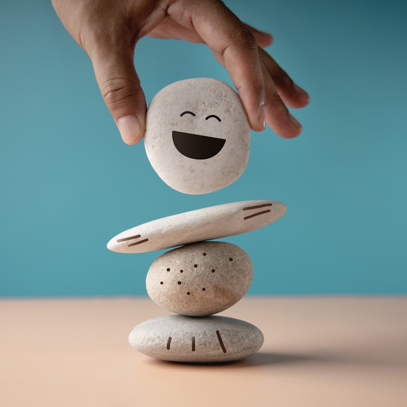 Enjoying Life Concept. Harmony and Positive Mind. Hand Setting White Natural Stone Stack to Balance....