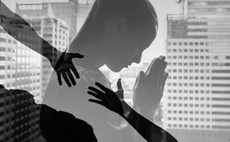 Young business woman praying to god asking for help.