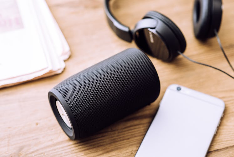 Black mini wireless portable bluetooth speaker for music listening.