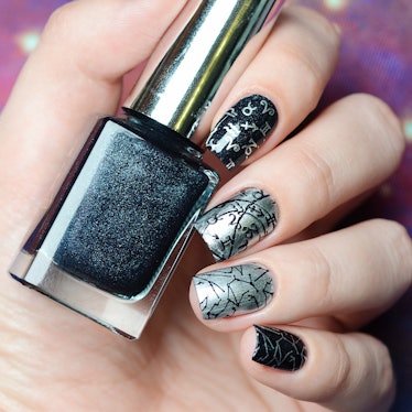 black and gray manicure with a constellation map pattern on a cosmic background