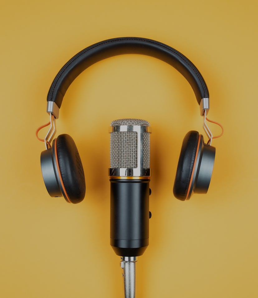 podcasting concept, directly above view of headphones and recording microphone on orange background