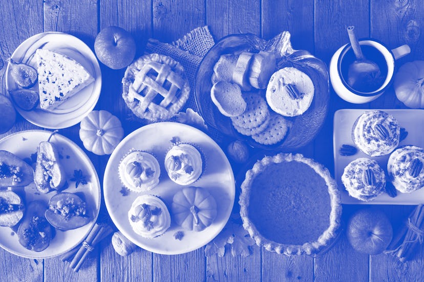 Autumn food concept. Selection of pies, appetizers and desserts. Above view table scene over a rusti...