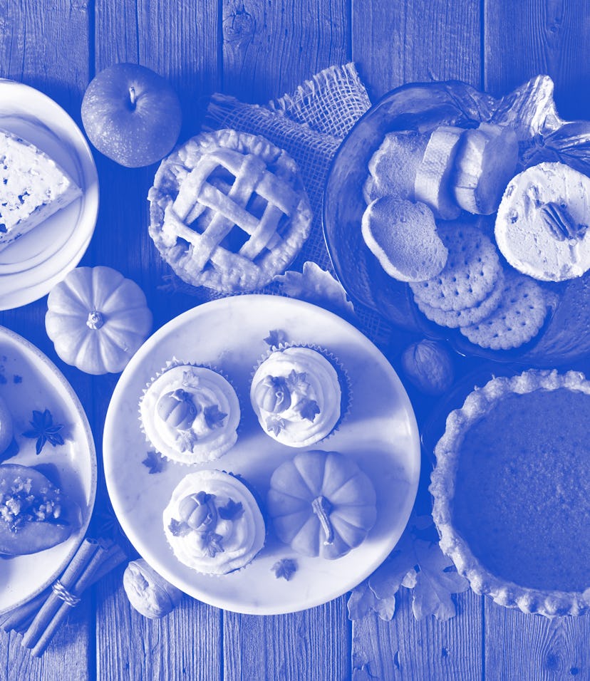Autumn food concept. Selection of pies, appetizers and desserts. Above view table scene over a rusti...