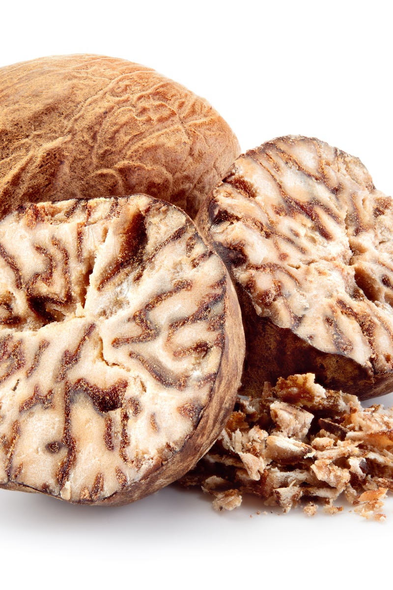 Nutmeg. Whole nut, half and powder isolated on white background.