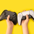 Kid holding game controllers in yellow background