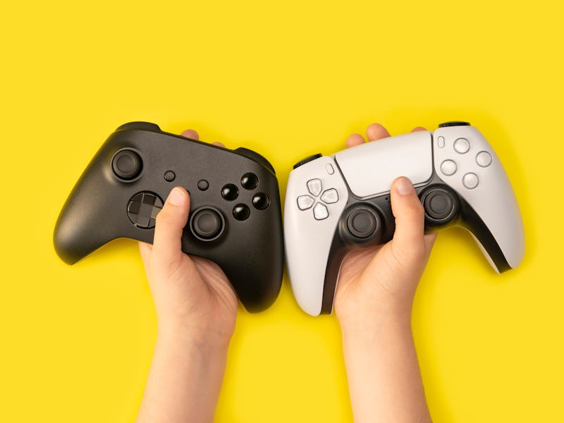 Kid holding game controllers in yellow background