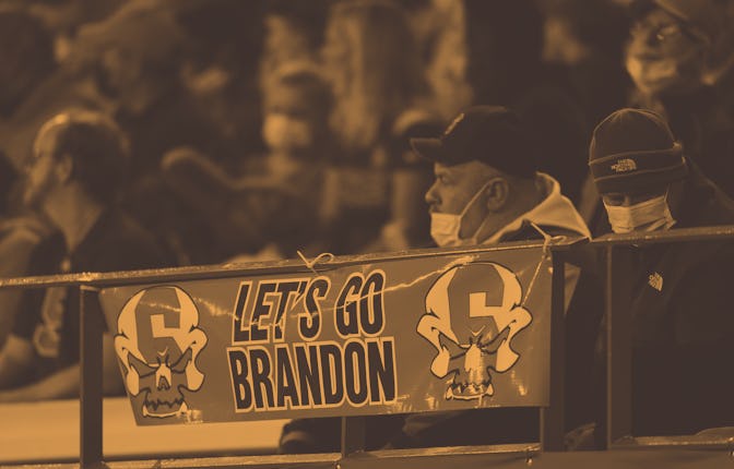 Sign reading "Let's go Brandon" is seen on the railing during the first half of an NCAA college foot...