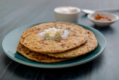 stuffed dal paratha with curd, pickle and white butter with selective focus