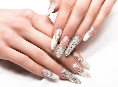 Rhinstoned and glitter nails with an updated french manicure style on hands.