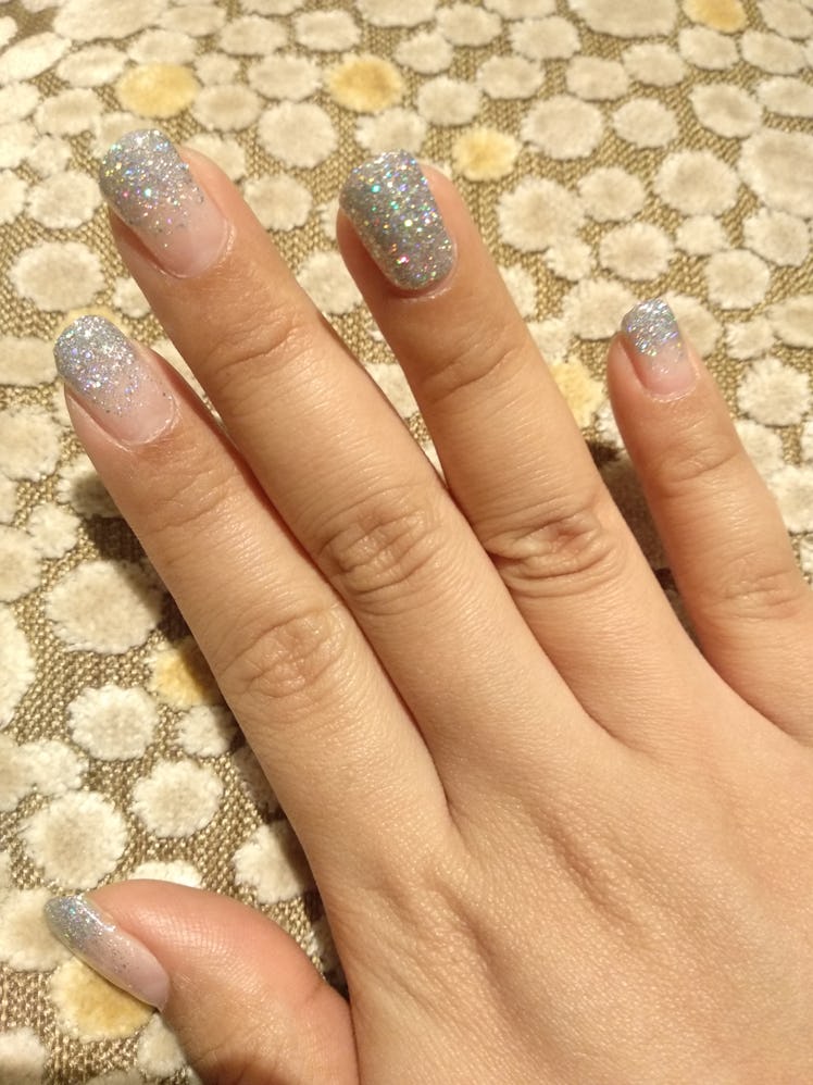 An ombre, glitter manicure with an accent nail.