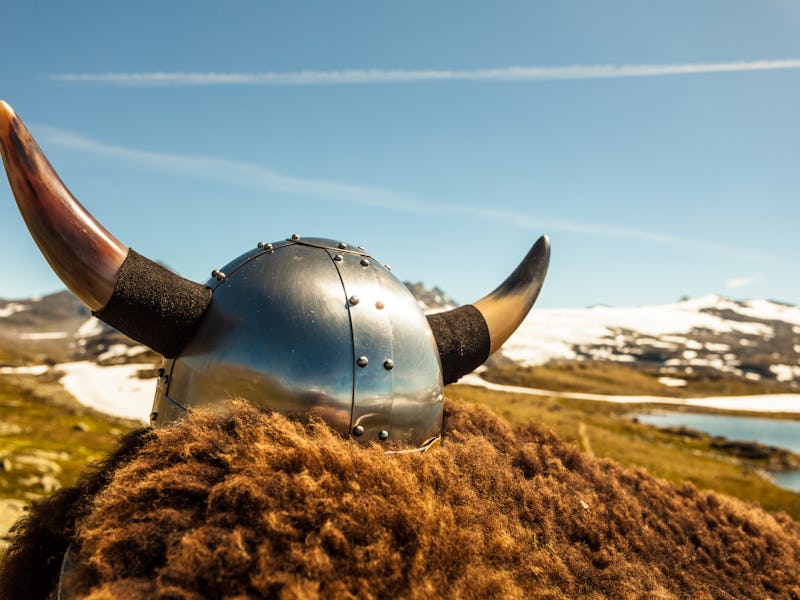 Viking helmet and brown fur on mountains nature in Norway. Tourism and traveling concept