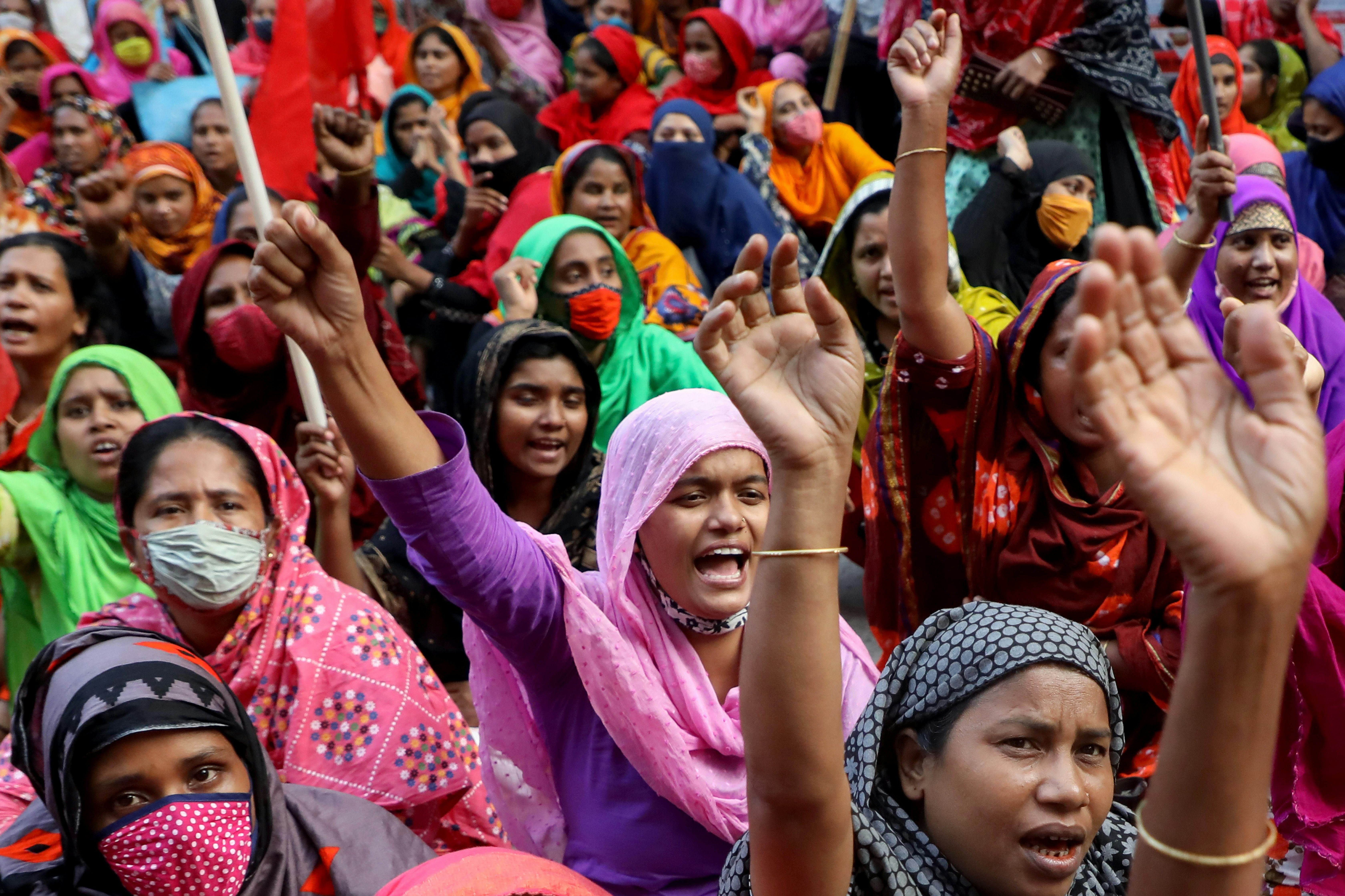 Protesters hold flags and chant slogans during the protest in Dhaka.
Garment workers of StyleCraft L...