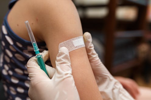 Doctor vaccinated in shoulder. Promotion disease prevention. Medical syringe with vaccine. Accidenta...