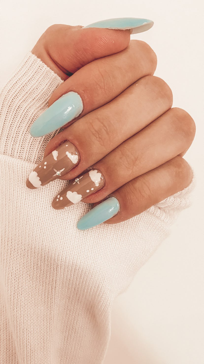 Cloud nail art with extension nails on nude and light blue nails, showcasing Libra nail designs.