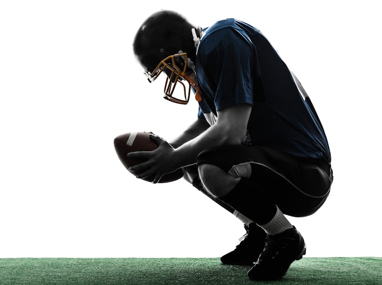 one caucasian defeated american football player man in silhouette studio isolated on white backgroun...