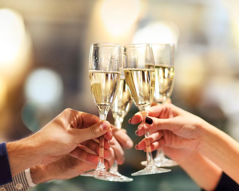 Celebration. People holding glasses of champagne making a toast. Champage with blurred background