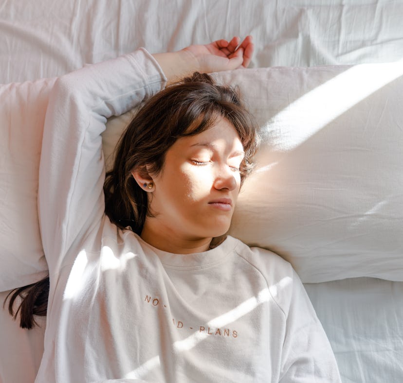 Why do I sleep with my arms above my head? Experts explain.