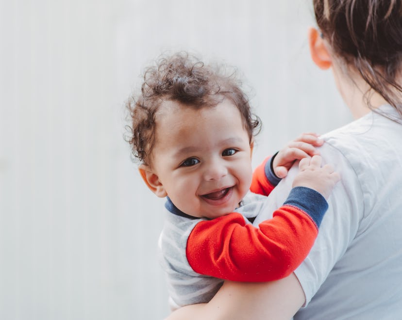 Mom holding baby in a story about Capricorn names