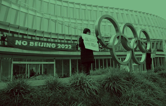 Protesters hold placards during a protest against Beijing 2022 Winter Olympics by activists of the T...