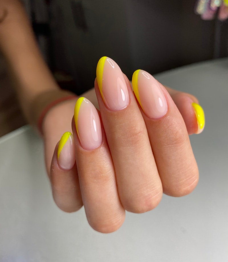 Yellow nail designs in 2021 ranged from abstract neon nails to pastel French tips.