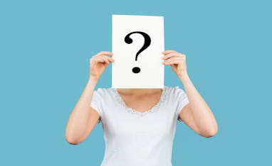 Unknown woman holding question mark. Girl holding paper question mark. Anonymous, woman question, in...