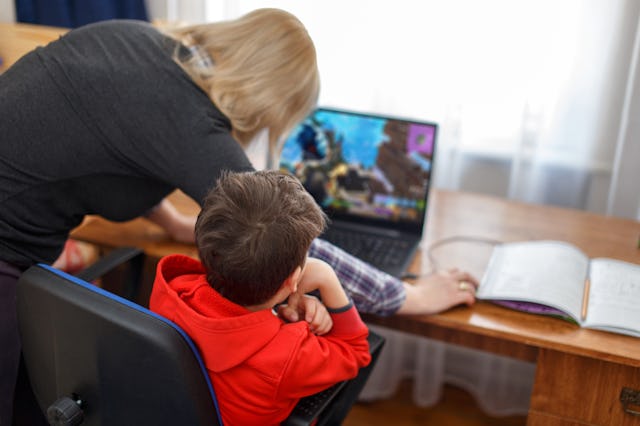 Mother turning off computer for computer addicted little gamer kid, internet and game dependency
