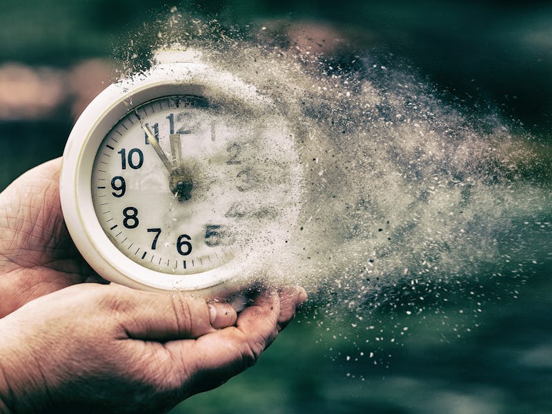 Retro alarm clock or vintage alarm clock in old hand. Time is running out concept shows clock that i...