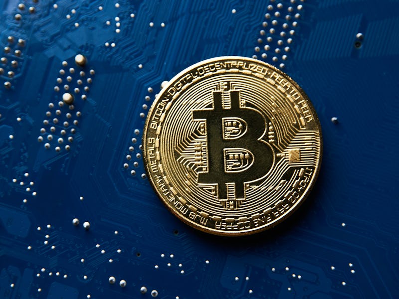 Bitcoin coin on blue circuit background. Cryptocurrency, virtual money. Blockchain technology, bitco...