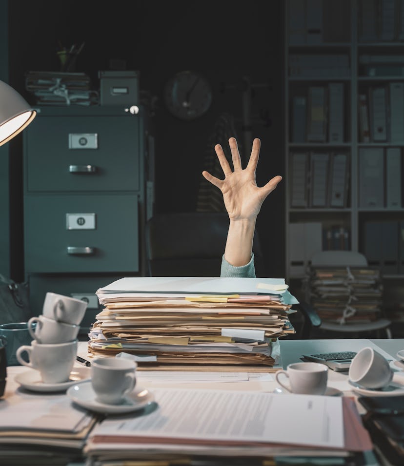 Desperate office worker overwhelmed with paperwork, she is asking help with her hand